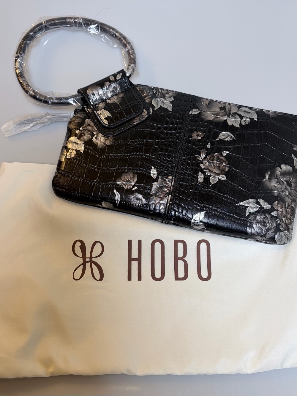 HOBO Wristlet Black with Silver Roses. Leather. New without tags.